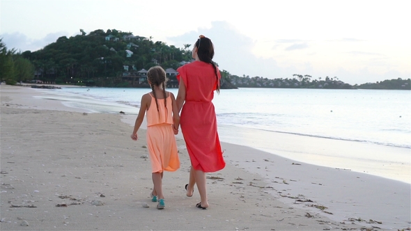 Young Beautiful Mother and Her Adorable Little Daughter Have Fun at Tropical Beach