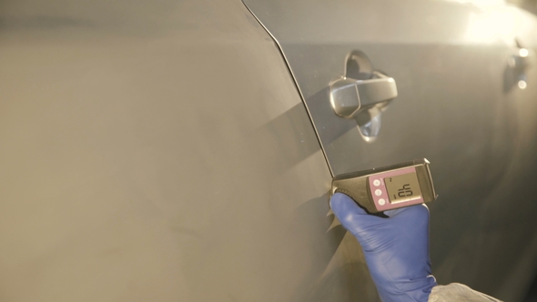 Measuring a Thickness of Primer on a Car Surface Using a Thickness Gauge