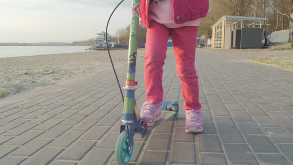 Girl on kids scooter