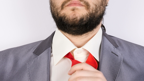 Businessman Arranging His Tie in Front of the Camera