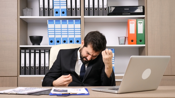 Businessman at His Workplace Relaxing By Playing Imaginary Guitar and Drums