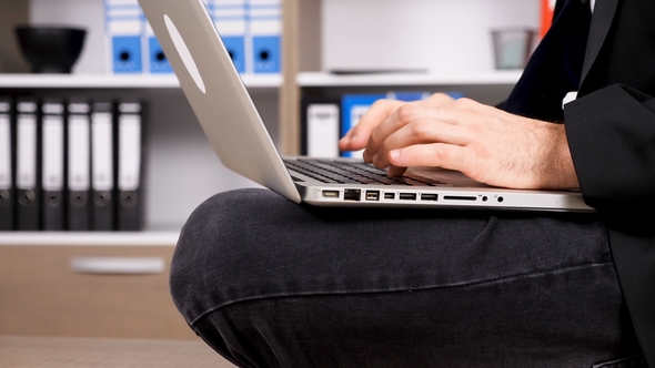 Businessman in Formal Suit Typing on the Laptop Keyboard