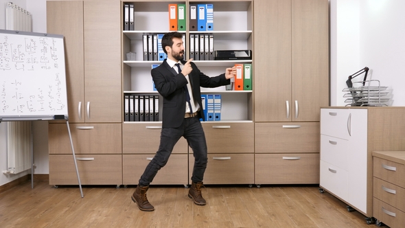 Happy and Successful Businessman Dancing in the Office