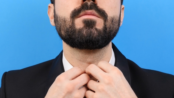 Businessman Closes the Last Button on the Shirt