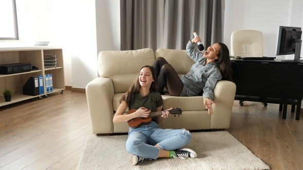 Two Sisters in the Living Room Having a Good Time
