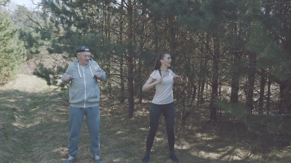 Happy Father and Daughter Work Out in the Early Forest.