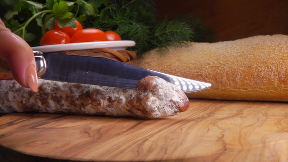 Chef Cuts Jerked Sausage with Knife