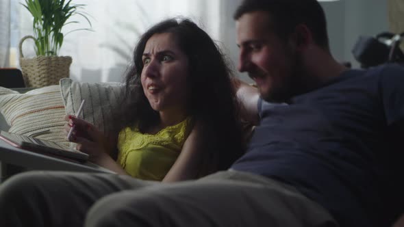 Woman Using Tablet and Talking with Husband