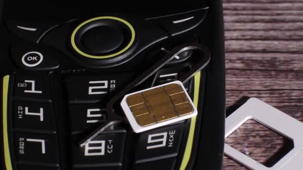 Closeup Shot Showing a Cellphone and the Parts of the Sim Card Slot
