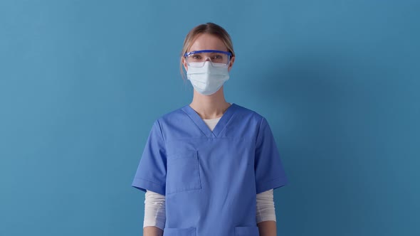 Nurse feels thankful, care and love for her patients, presses palms on chest near heart