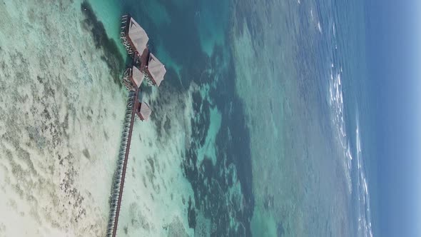 Vertical Video House on Stilts in the Ocean on the Coast of Zanzibar Tanzania Aerial View