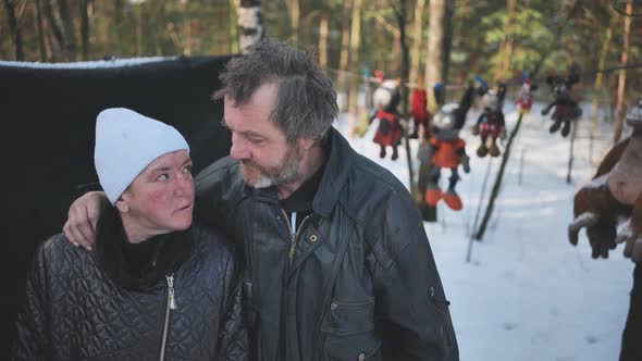 A Homeless Woman and a Man Pose in the Woods in Winter