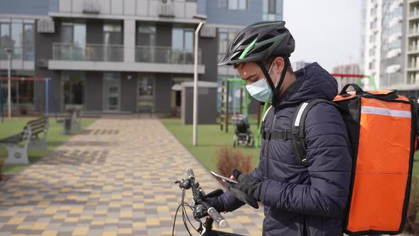 Masked Courier Taking Delivery Order Using Phone