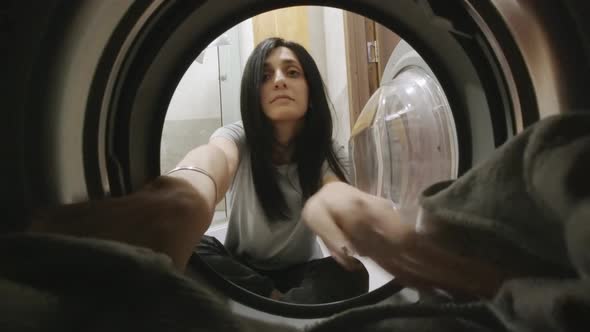 Slomo Woman Put Clothes To Wash Machine And Spin Them