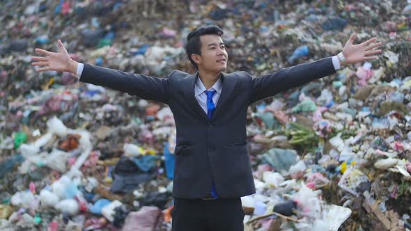 Businessman Enjoy, Mountain Of Garbage At Background