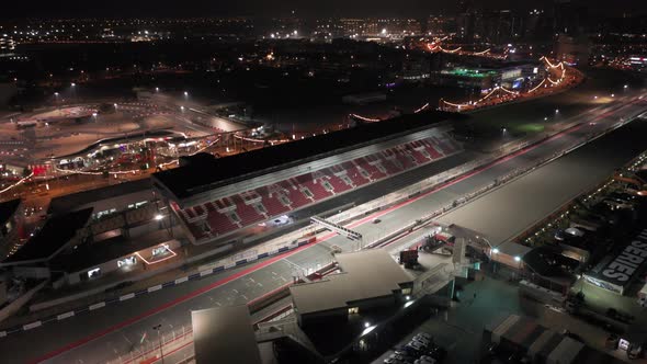 Aerial view of Dubai Autodrome grand stand, racing during night endurance competition