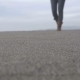 The Girl Is Walking Along the Sand - VideoHive Item for Sale