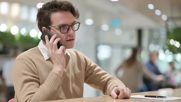 Man Talking on Smartphone in Office