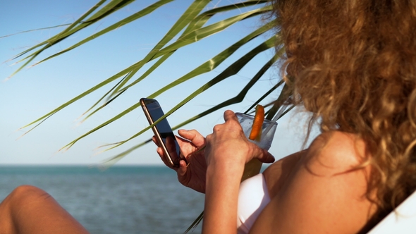 Young Girl in Bikini on Beach with Party Cocktail