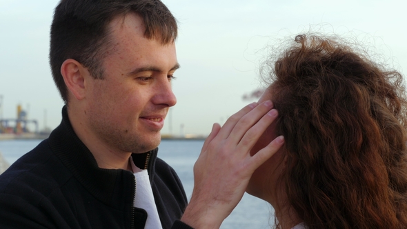 Young Romantic Couple in Trendy Wear on Date, Enjoying Moment of Closeness on Sea or Ocean