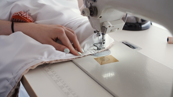 Woman Working with Sewing Machine Making Dress