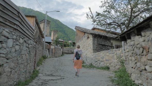 Girl Walks in the Old City Mestia, Georgia