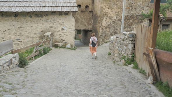 Girl Walks in the Old City Mestia, Georgia