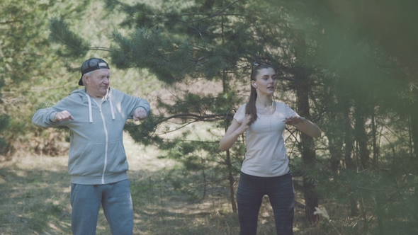 Happy Father and Daughter Work Out in the Early Forest.