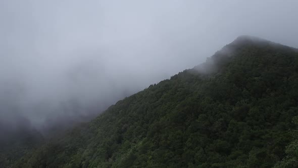 Drone view of mountains under clouds