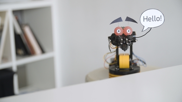 Funny Robot Says HELLO. Experiment with Intelligent Manipulator. Industrial Robot Model with Funny