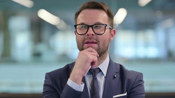 Portrait of Pensive Middle Aged Businessman Thinking