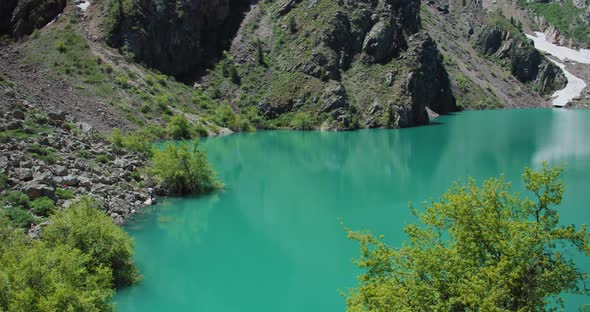 Mountain Lake of green and blue color Urungach. Located in Uzbekistan, Central Asia. 6 out of 10