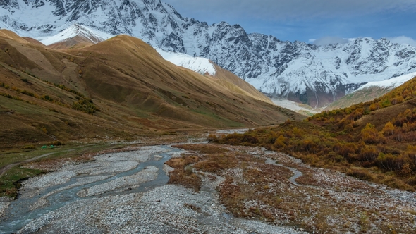 Road Running down to Amazing Touristic Place near River in Mountain Valley