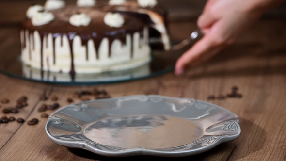 Putting a Piece of Chocolate Coffee Cake in a Plate