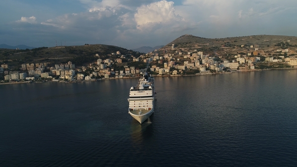 Aerial View of Luxury Cruise Ship with City in the Coast at Sunset in Albania