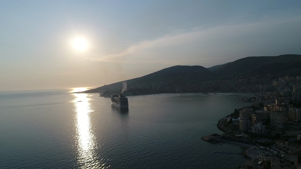 Aerial View of Luxury Cruise Ship with City in the Coast at Sunset. Albania