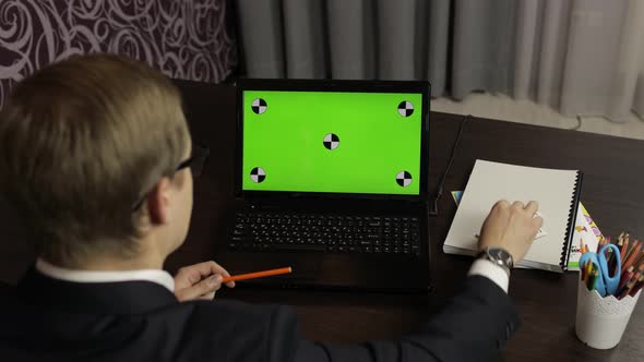 Man Teacher Making Online Video Call on Laptop. Green Screen. Distance Education
