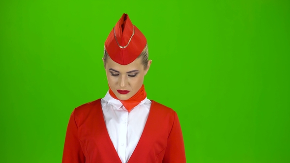Stewardess Looks Up and Smiles. Green Screen