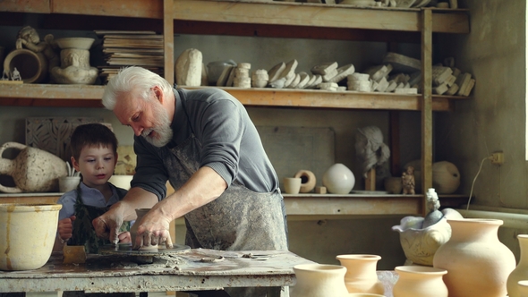 Professional Potter Is Cutting Ceramic Pot From Throwing Wheel