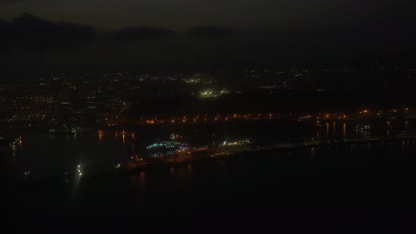 Approaching Barcelona airport at night. Lighted city line on the shore of the mediteranean sea. Shot