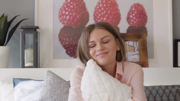 Girl Hugs a Pillow in Bed