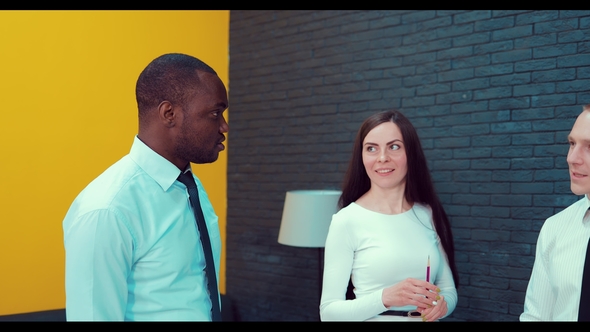 Team of Multi Ethnic Business People in City Clothes Meeting in a Modern Office Boardroom