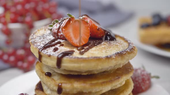 Pancakes with Berries Topped with Liquid Chocolate