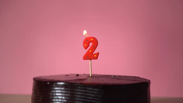 Chocolate Birthday Cake with Wick Lighting Trying to Blowout Candle