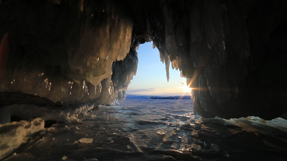Ice Cave with Icicles at Sunset at Winter Baikal