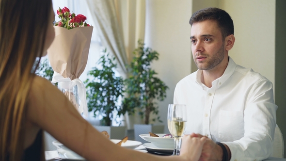 Well Dressed Handsome Guy Is Making a Proposal To Young Lady While Dining in Restaurant