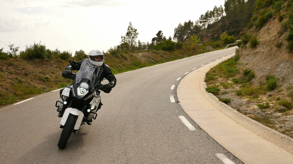 Motorcyclist Driving his Sports Motorbike on a Curvy Road