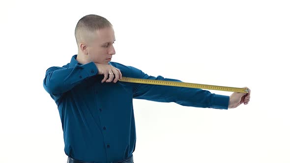 Guy in Dark Blue Shirt Holds Yellow Measuring Tape