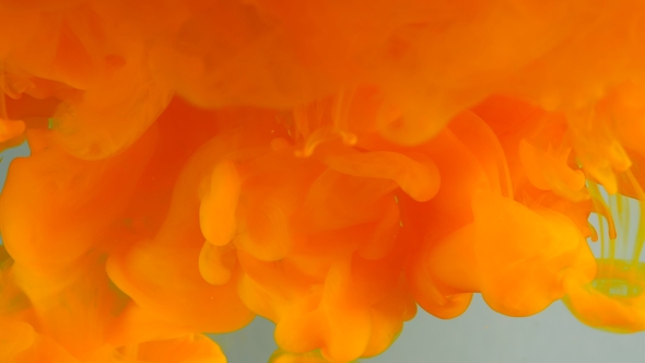 Ink in Water. Colour Orange Glitter Paint Reacting in Water Creating Abstract Cloud Formations alt