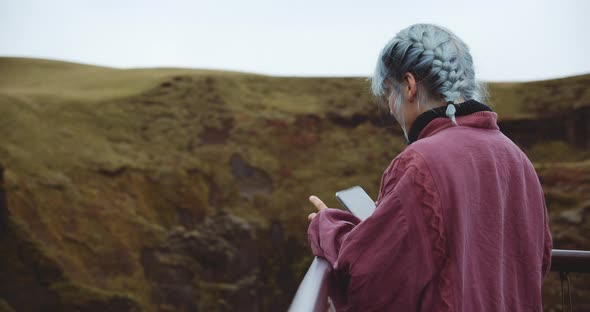 Woman Using Phone To Photograph The Fjadrargljufur Canyon